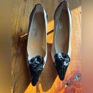 Black and cream Chanel kitten heel pumps with CC and iconic camellia flower